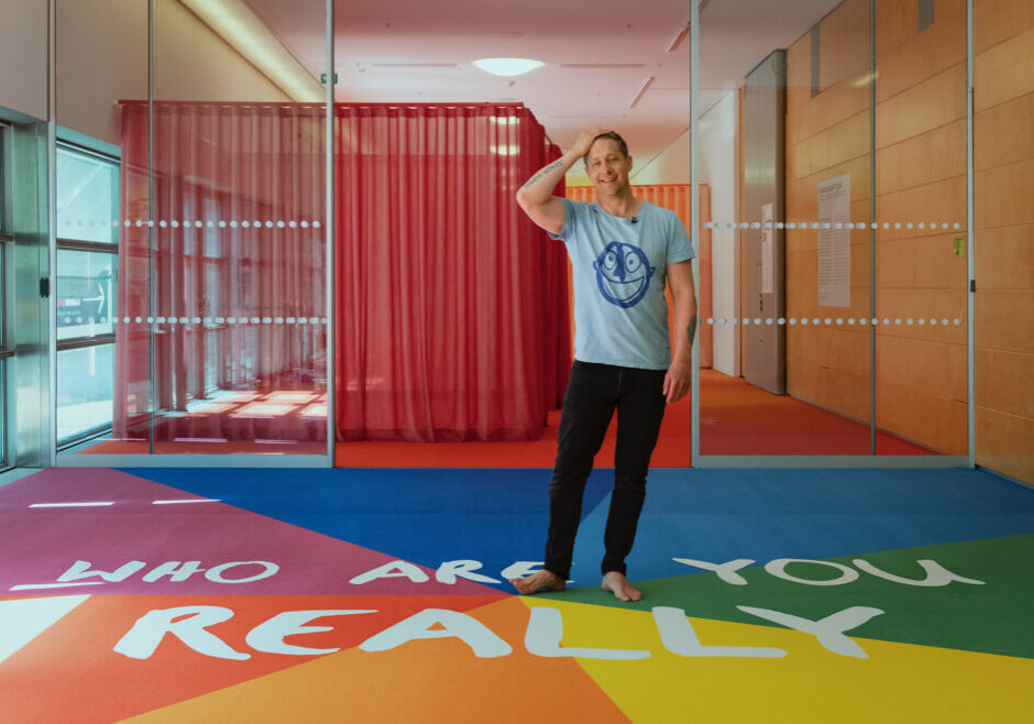 The Artist standing in front of the exhibition